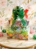 Passionfruit Escape Spa Gift Basket in floral gift box with green pull bow and clear cellophane wrap featuring passionfruit body scrub and assorted spa products
